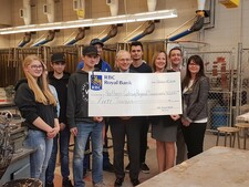 NGPS Superintendent Kevin Andrea and RBC Manager, Whitecourt, Tammy Collins pose for a photo with students and representatives from RBC.